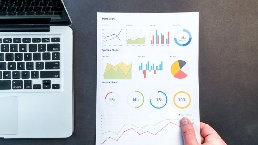 person holding chart and bar graph